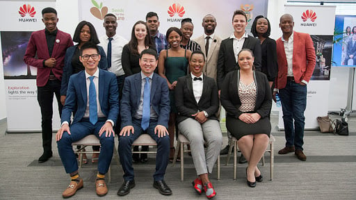 Minister Stella Ndabeni-Abrahams and Huawei officials flanked by the 2019 Seeds for the Future cohort.